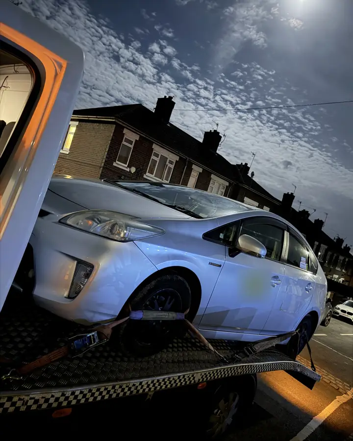 Toyota Prius loaded after dark, under a full moon